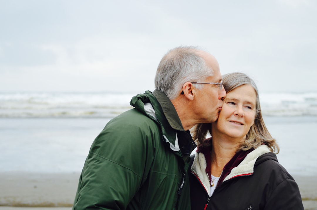 Plano Life Insurance for Tech Professionals: Your Year-End Planning Guide 6 man kissing woman on check beside body of water