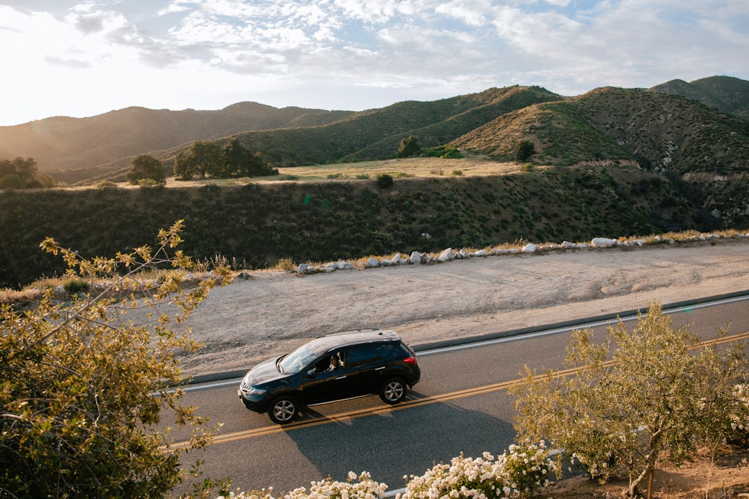 Texas Holiday Travel Insurance: What Your Auto Policy Covers (And Doesn't) During Christmas Road Trips 3 a car driving down a road with mountains in the background
