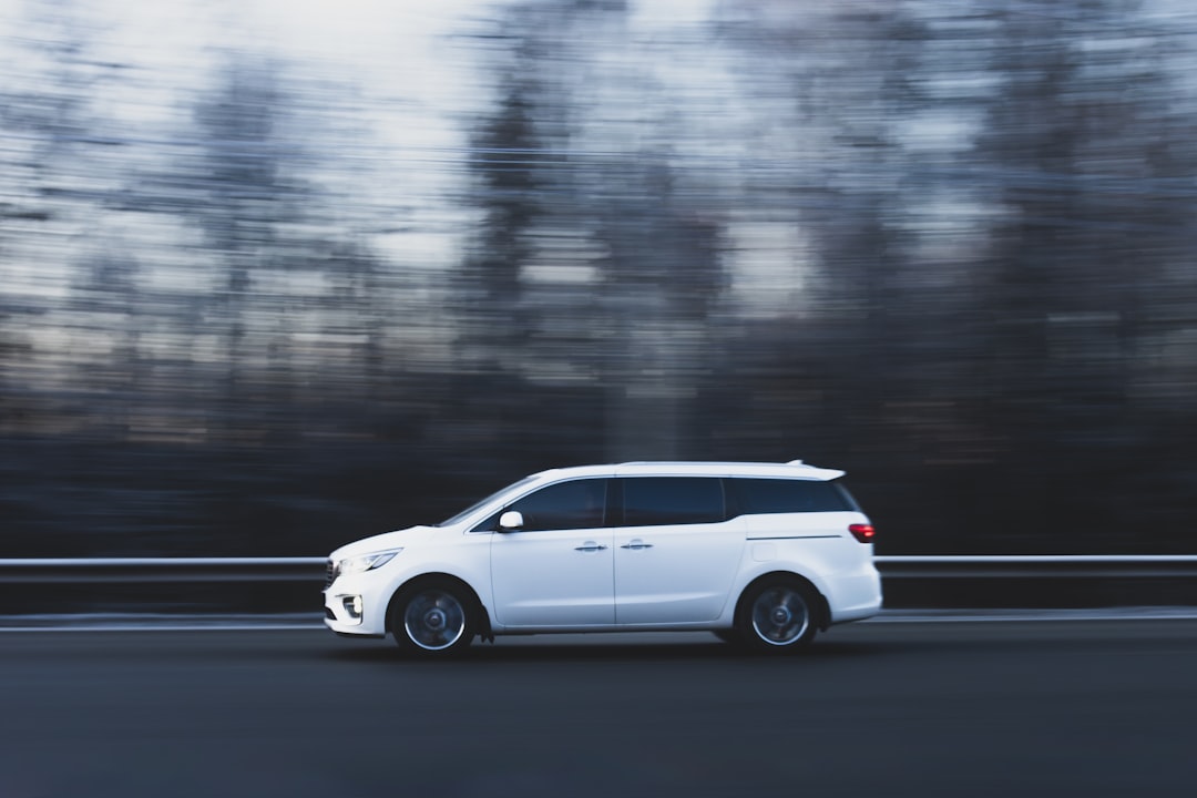 Texas Holiday Travel Insurance: What Your Auto Policy Covers (And Doesn't) During Christmas Road Trips 6 A white car driving down a road next to a forest